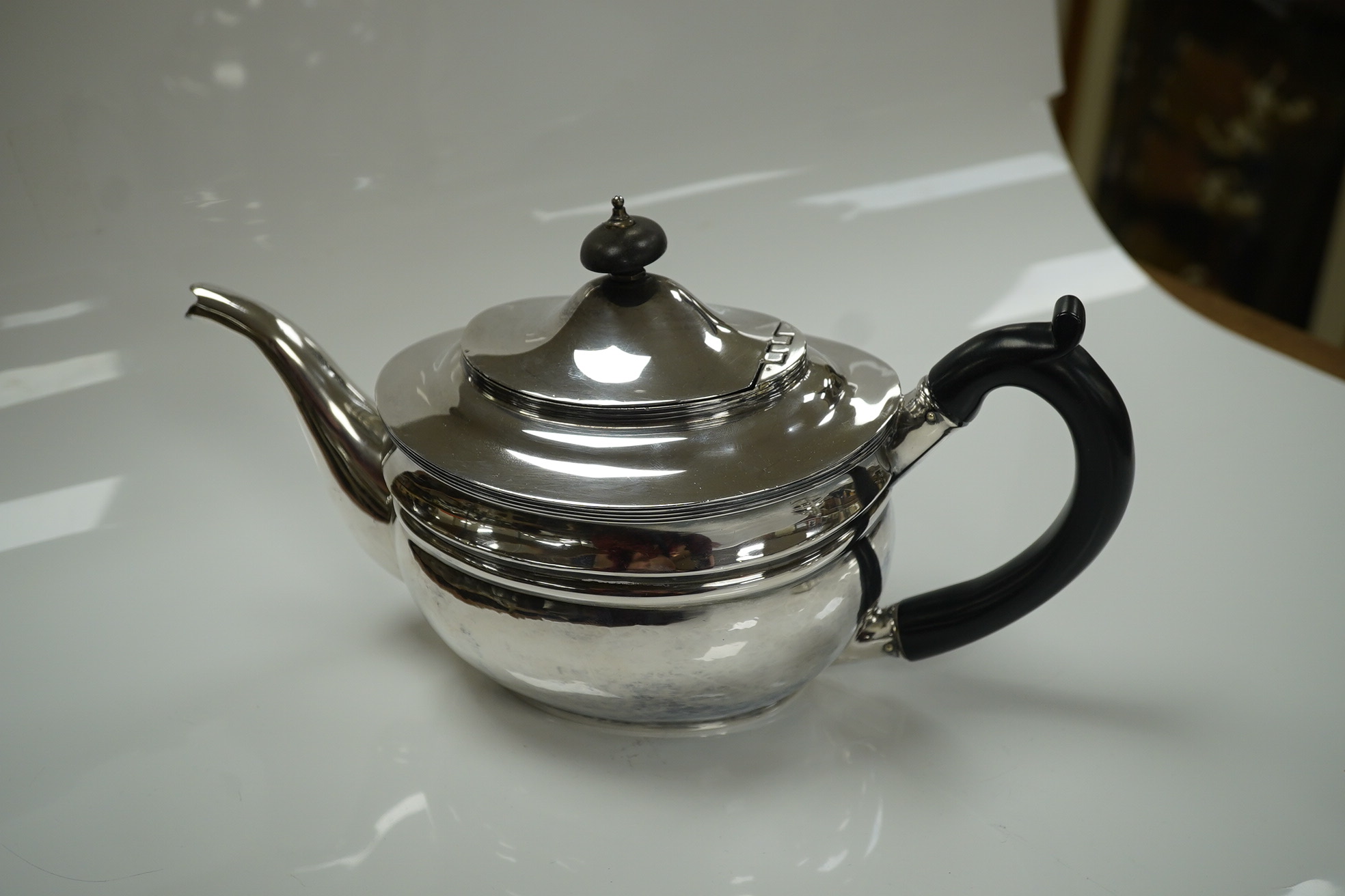 An Edwardian silver teapot and two handled sugar bowl by Charles Stuart Harris & Sons, London 1907, gross weight 23.4oz. Condition - poor to fair